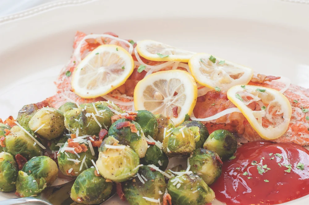 Display of grilled brussels sprouts and salmon dish