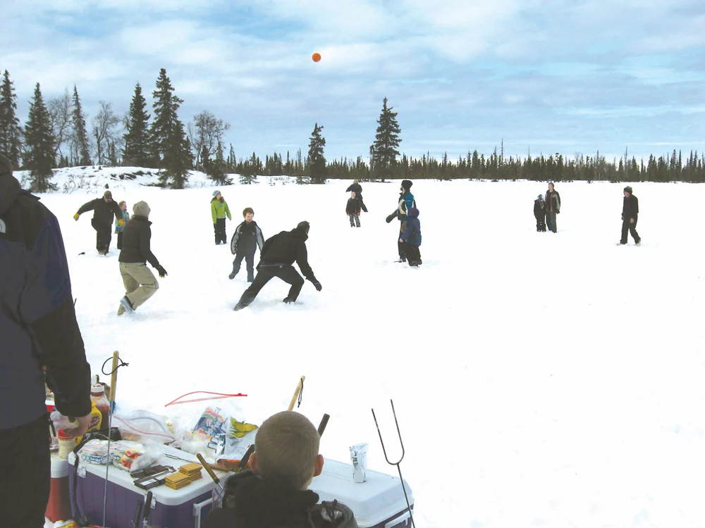Group of people playing with ball in the snow.