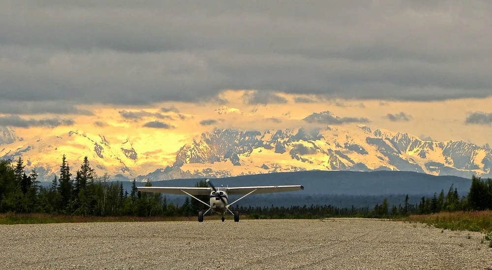 A plane lands on a gravel runway in Beluga, Alaska. The only way to access the river is by plane or boat. Credit: Paul Moinester
