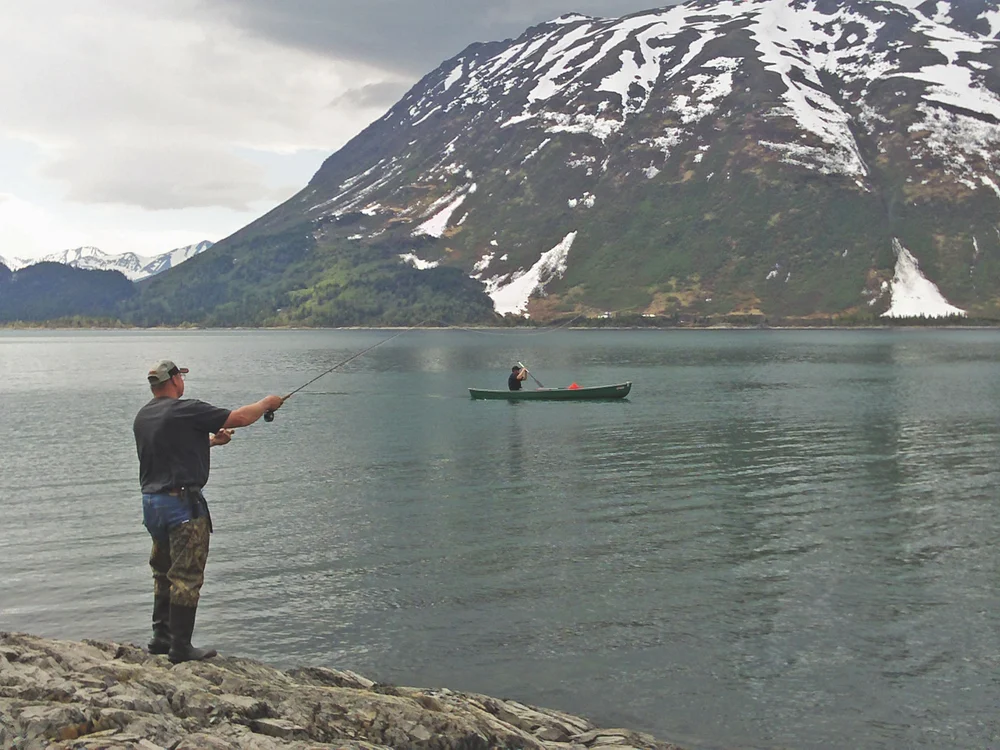 Man fly fishing at the lake shore.
